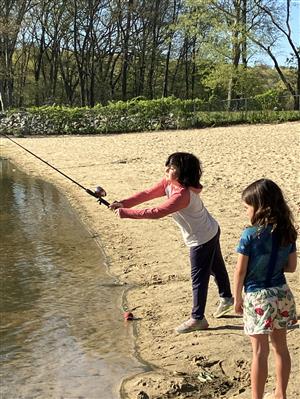 Child with fishing pole at the waters edge 